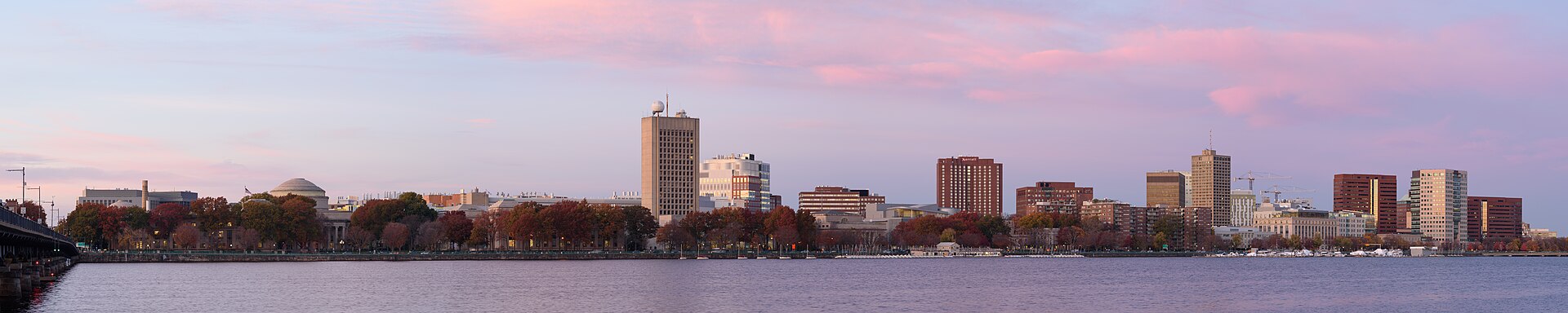 The Cambridge skyline across the Charles River at dusk, seen from the Harvard Bridge, with MIT's Great Dome at the left and Kendall Square at the right.